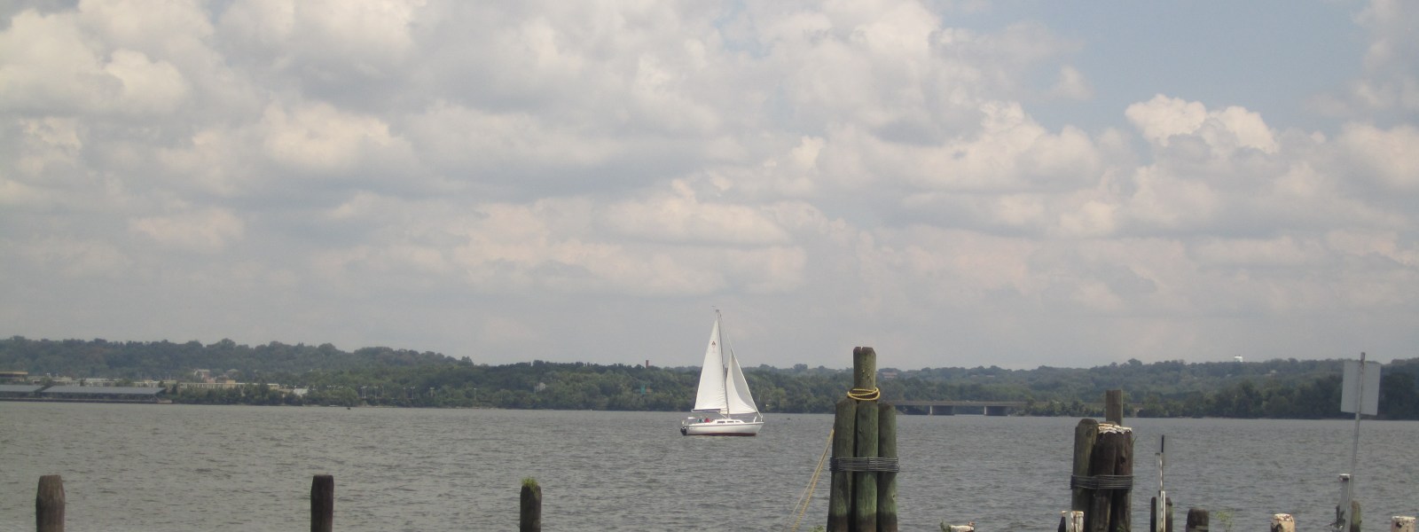 A sailboat on the Potomac seen from the Old Town Alexandria waterfront